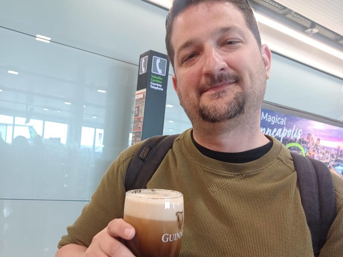 Man holding a Guinness Beer